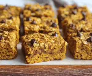 Delicious baked breakfast oatmeal pumpkin bars topped with cinnamon and nuts, perfect for a nutritious morning treat