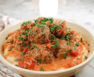 Delicious gluten-free meatballs served on a plate with fresh herbs and marinara sauce, perfect for a flavorful and allergy-friendly meal.
