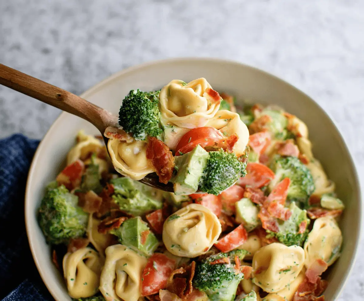 Colorful Broccoli BLT Tortellini Salad with crispy bacon, fresh broccoli, cherry tomatoes, and cheese in a vibrant bowl