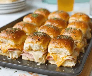 Delicious ham and cheese sliders perfect for game day, featuring toasted buns, melted cheese, and savory ham slices