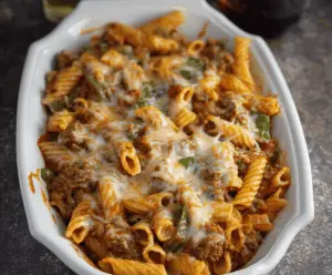 Creamy Slow Cooker Pasta Casserole topped with melted cheese and fresh herbs, ready to serve