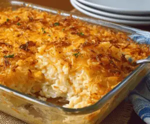 Delicious Grandma's Hash Brown Casserole topped with melted cheese and crispy bacon bits.