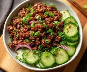 Delicious spicy keto Korean ground beef served with fresh cucumber salad, perfect for low-carb meals.