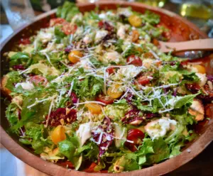 Fresh Pizza Night Salad with colorful vegetables and ripe tomatoes for a healthy dinner option.
