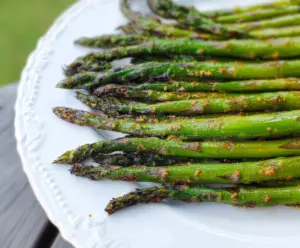 Delicious grilled asparagus topped with Garam Masala seasoning, perfect for a flavorful vegetarian dish.