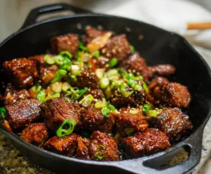 Delicious Korean Steak Bites with savory marinade and crispy edges on a wooden serving board.