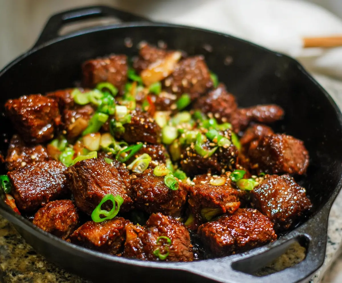 Delicious Korean Steak Bites with savory marinade and crispy edges on a wooden serving board.