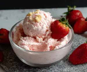 Delicious Strawberry Cottage Cheese Ice Cream in a bowl, showing a creamy texture and fresh strawberry pieces, perfect for high-protein low-carb dessert lovers.